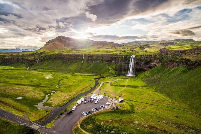 Reykjavik: Glacier Lagoon, Diamond Beach & South Coast Day Tour - Vík: black sand village views and Reynisdrangar in the distance